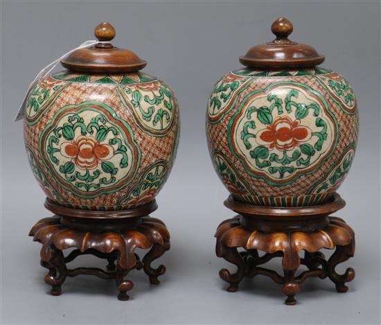 A pair of 19th century Chinese enamelled porcelain jars with wood covers and stands height 25cm